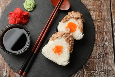 Photo of Tasty onigiri (Japanese rice balls) with tuna served on wooden table, top view