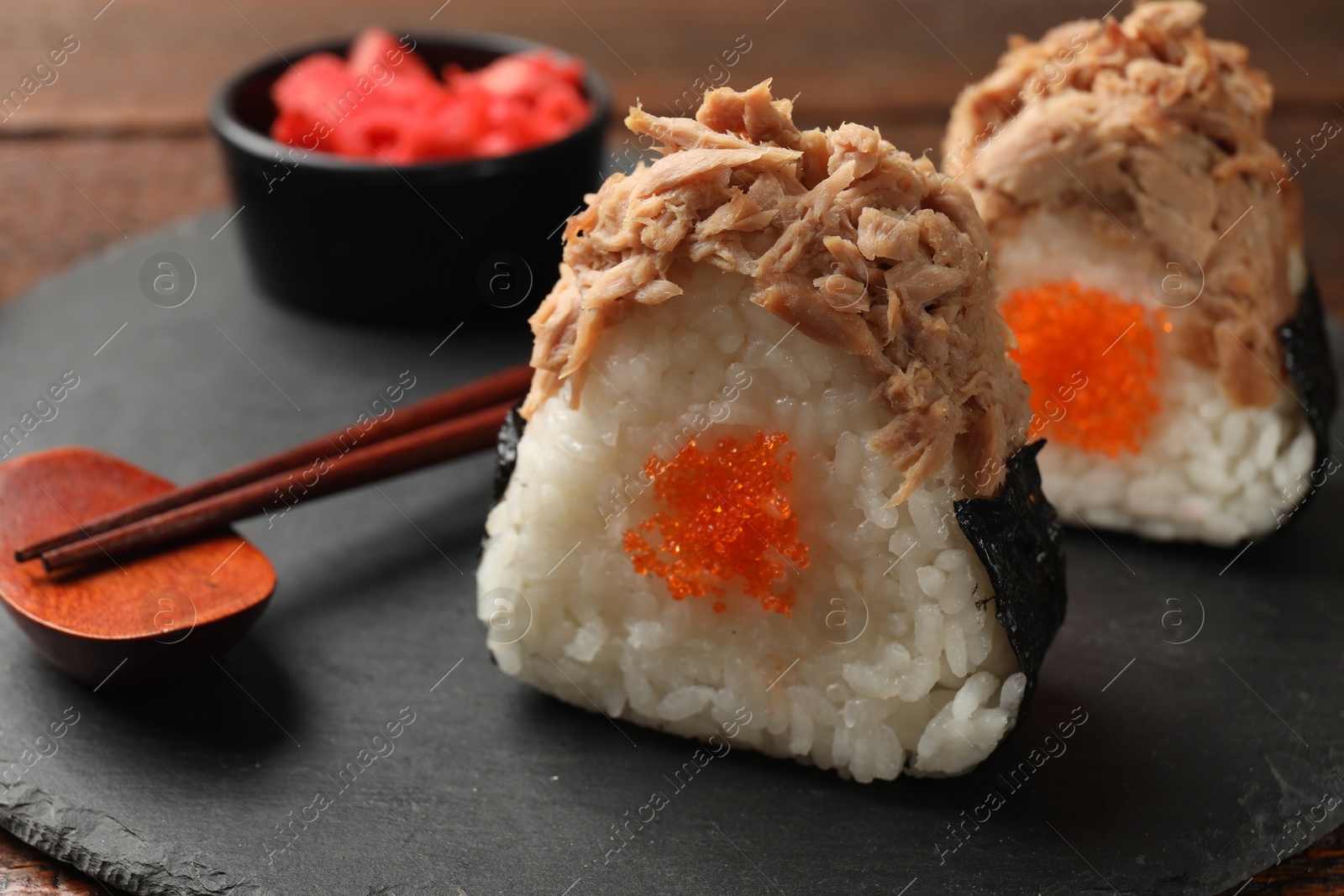 Tasty onigiri (Japanese rice balls) with tuna served on table, closeup Photo of Tasty onigiri (Japanese rice balls) with tuna served on table, closeup