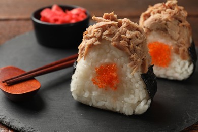 Photo of Tasty onigiri (Japanese rice balls) with tuna served on table, closeup