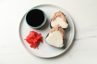 Photo of Tasty onigiri (Japanese rice balls) with tuna served on white marble table, top view