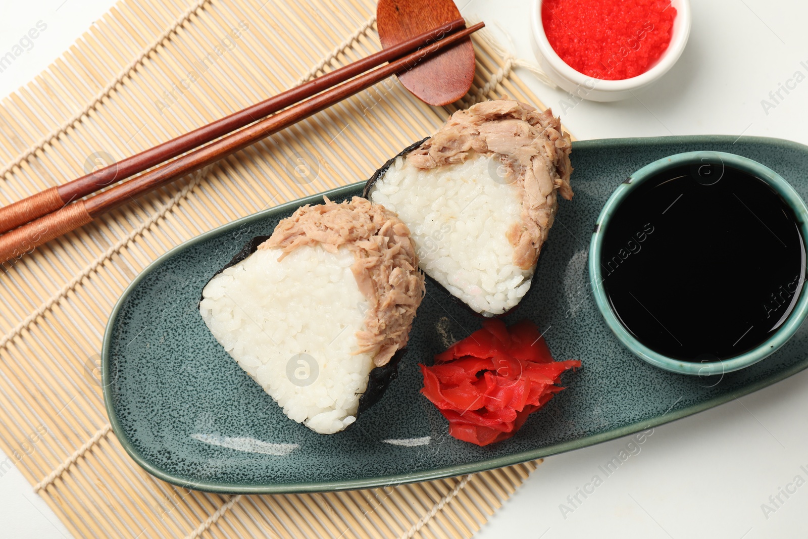 Tasty onigiri (Japanese rice balls) with tuna served on white table, flat lay Photo of Tasty onigiri (Japanese rice balls) with tuna served on white table, flat lay