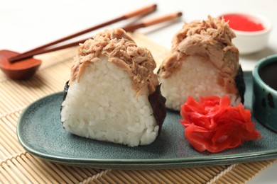Photo of Tasty onigiri (Japanese rice balls) with tuna served on table, closeup