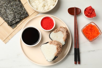Photo of Tasty onigiri (Japanese rice balls) with tuna served on white marble table, flat lay
