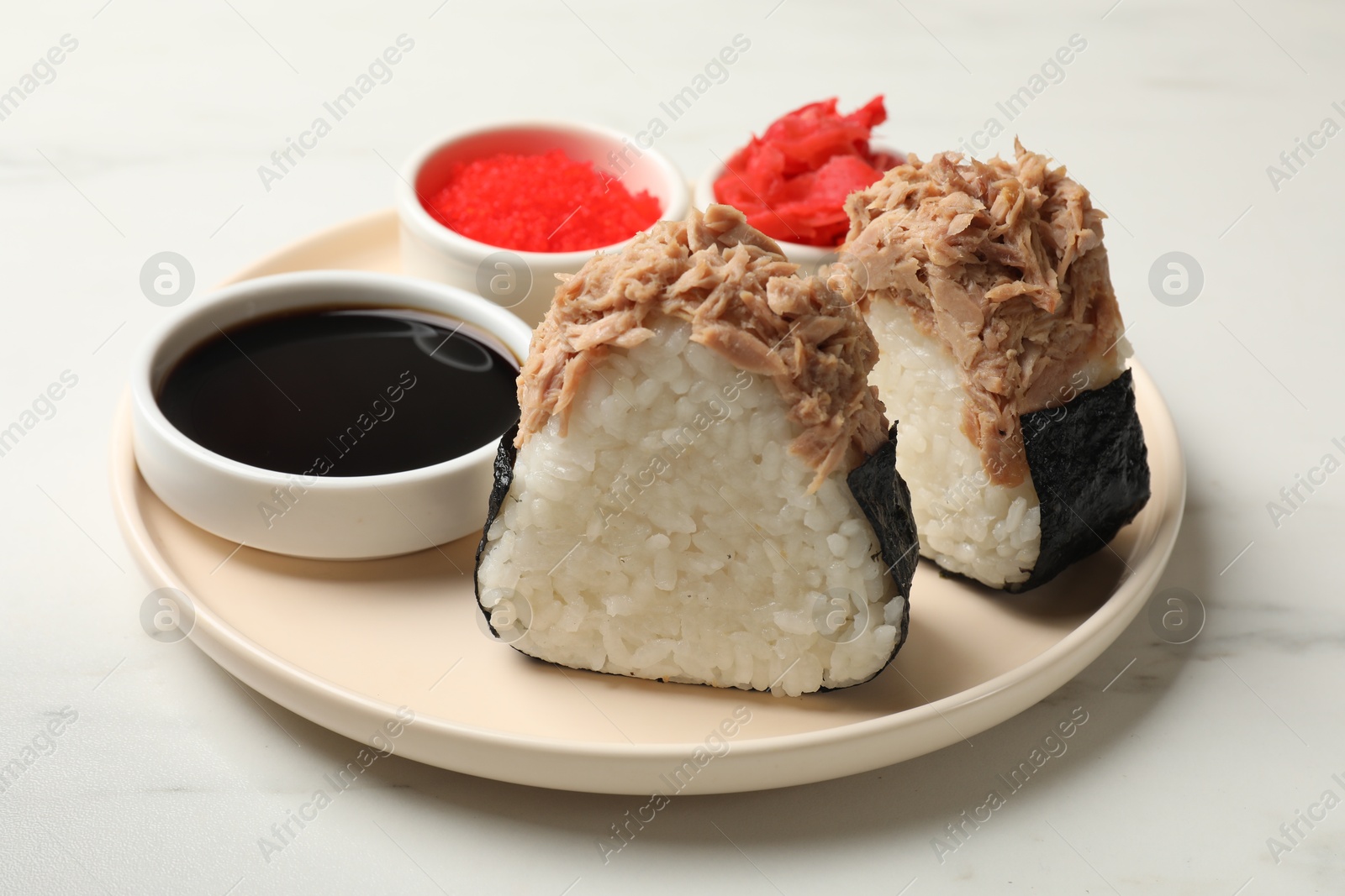 Tasty onigiri (Japanese rice balls) with tuna served on white marble table, closeup Photo of Tasty onigiri (Japanese rice balls) with tuna served on white marble table, closeup