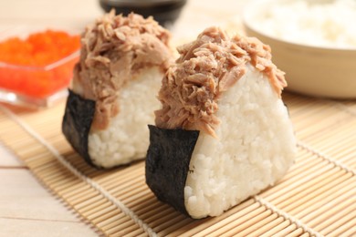 Photo of Tasty onigiri (Japanese rice balls) with tuna served on table, closeup