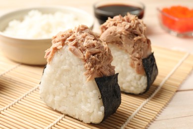 Photo of Tasty onigiri (Japanese rice balls) with tuna served on table, closeup