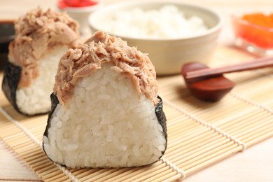 Photo of Tasty onigiri (Japanese rice balls) with tuna served on table, closeup