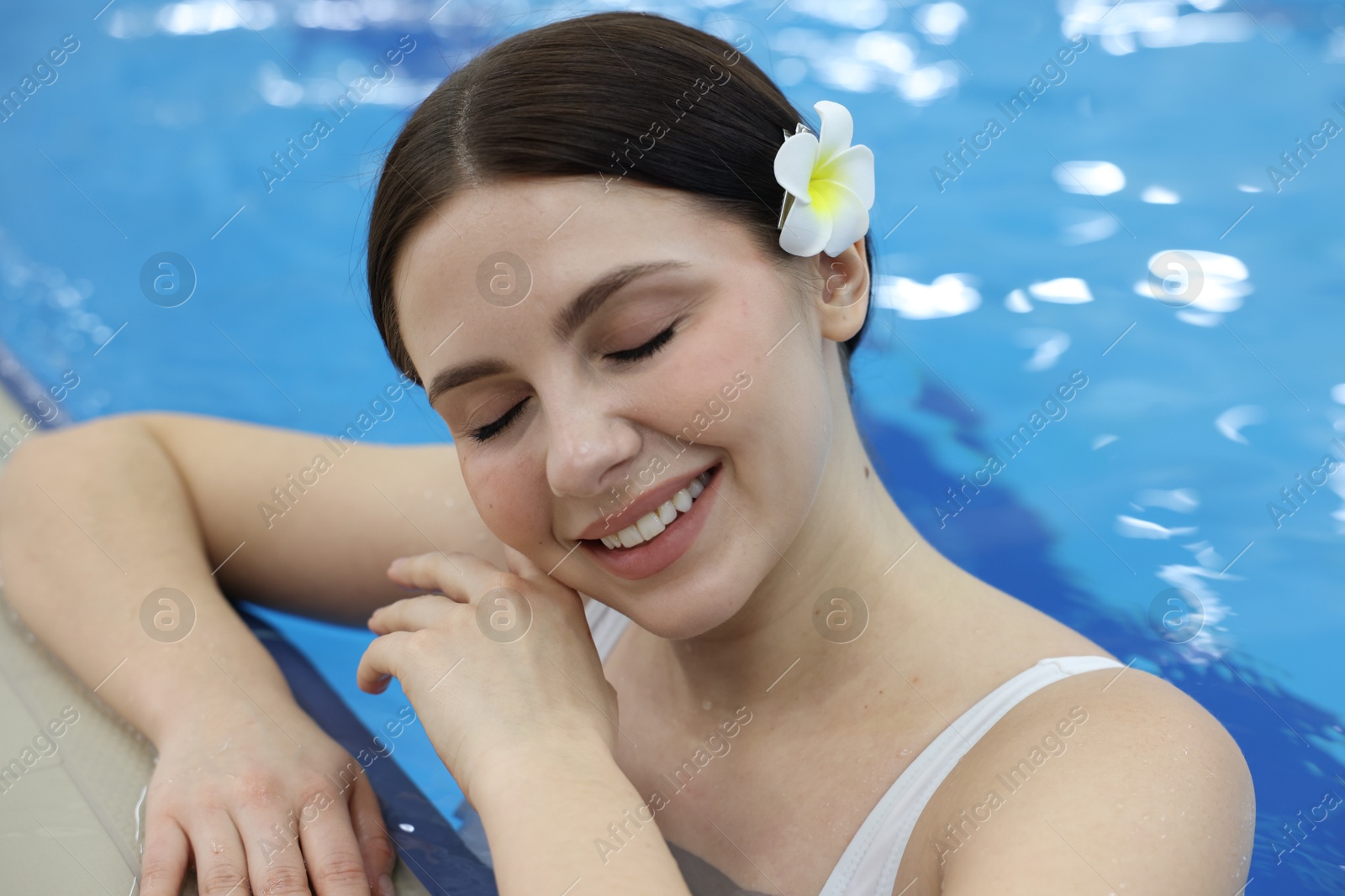 Photo of Beautiful young woman in indoor swimming pool