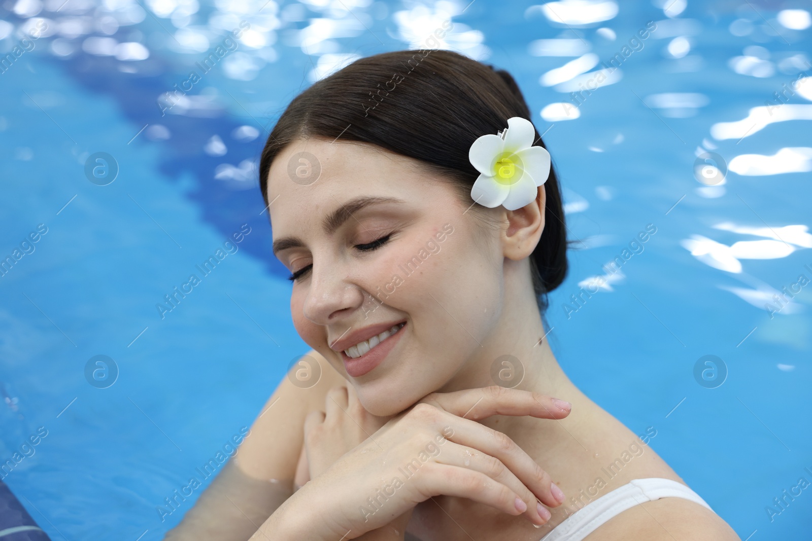 Photo of Beautiful young woman in indoor swimming pool