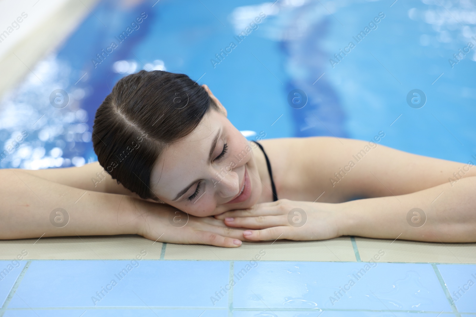 Photo of Beautiful young woman in indoor swimming pool