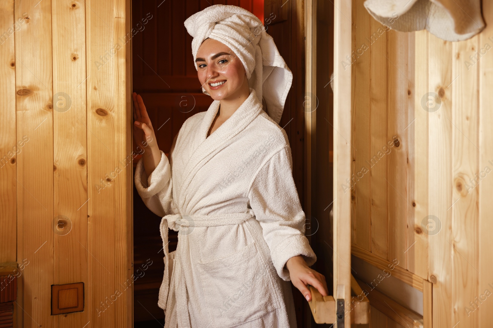 Photo of Beautiful woman in bathrobe relaxing at sauna