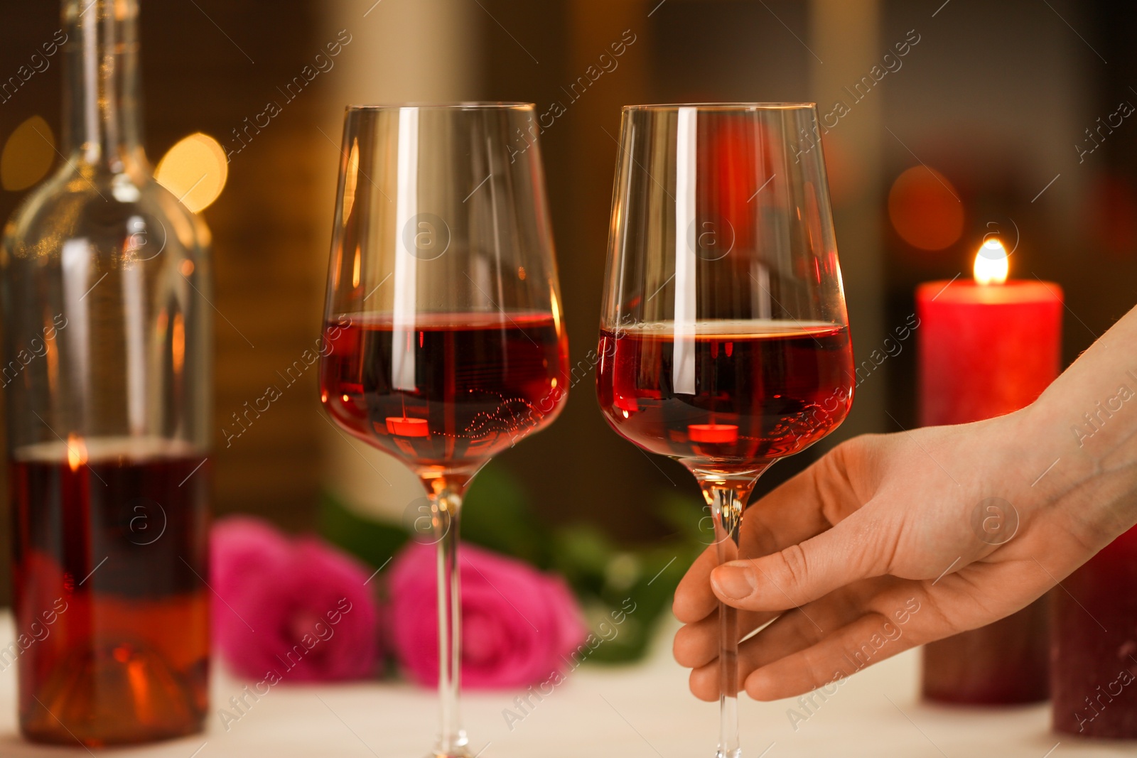 Photo of Woman with glass of red wine in restaurant, closeup. Romantic dinner