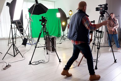 Man and woman working in modern film studio