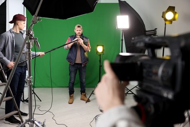 Group of people working in modern film studio, selective focus