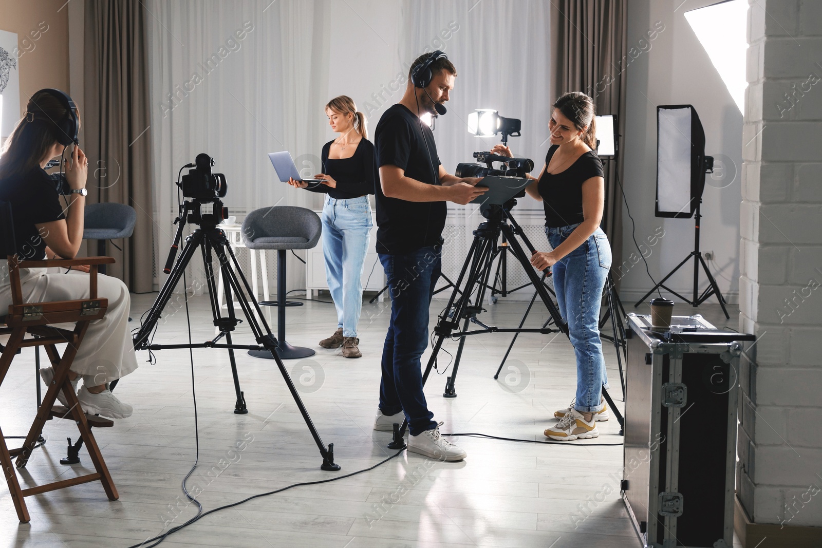 Photo of Group of people working in modern professional film studio