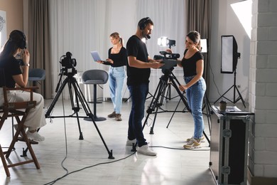 Group of people working in modern professional film studio