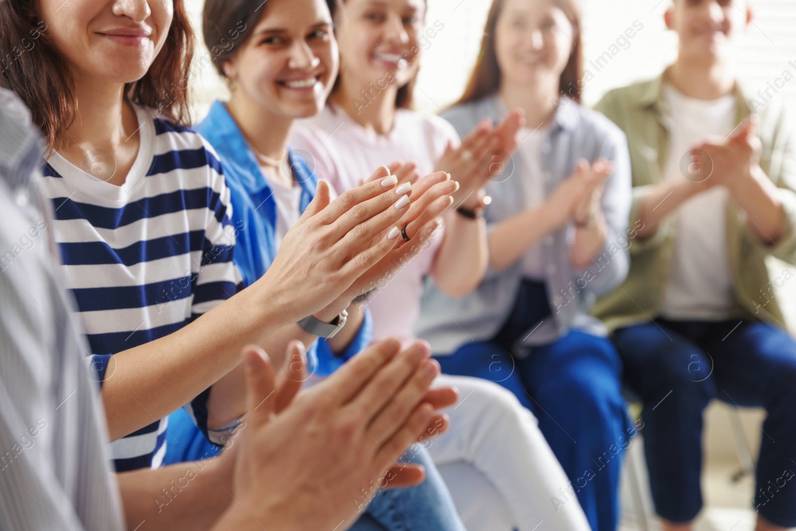 Photo of People applauding during meeting indoors, closeup view