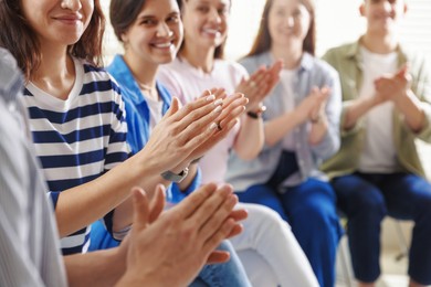 People applauding during meeting indoors, closeup view