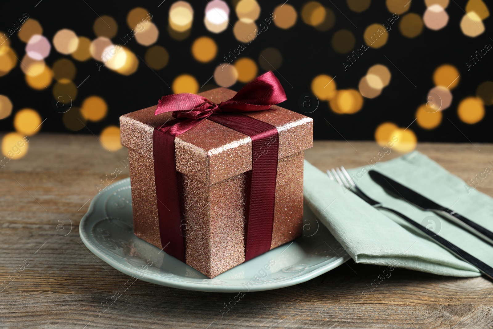 Photo of Beautiful table setting with romantic gift on wooden background, closeup