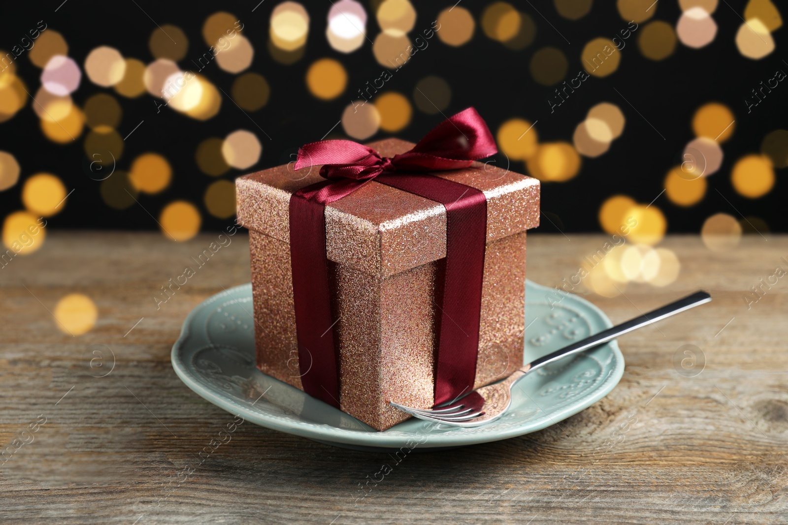 Photo of Beautiful table setting with romantic gift on wooden background, closeup