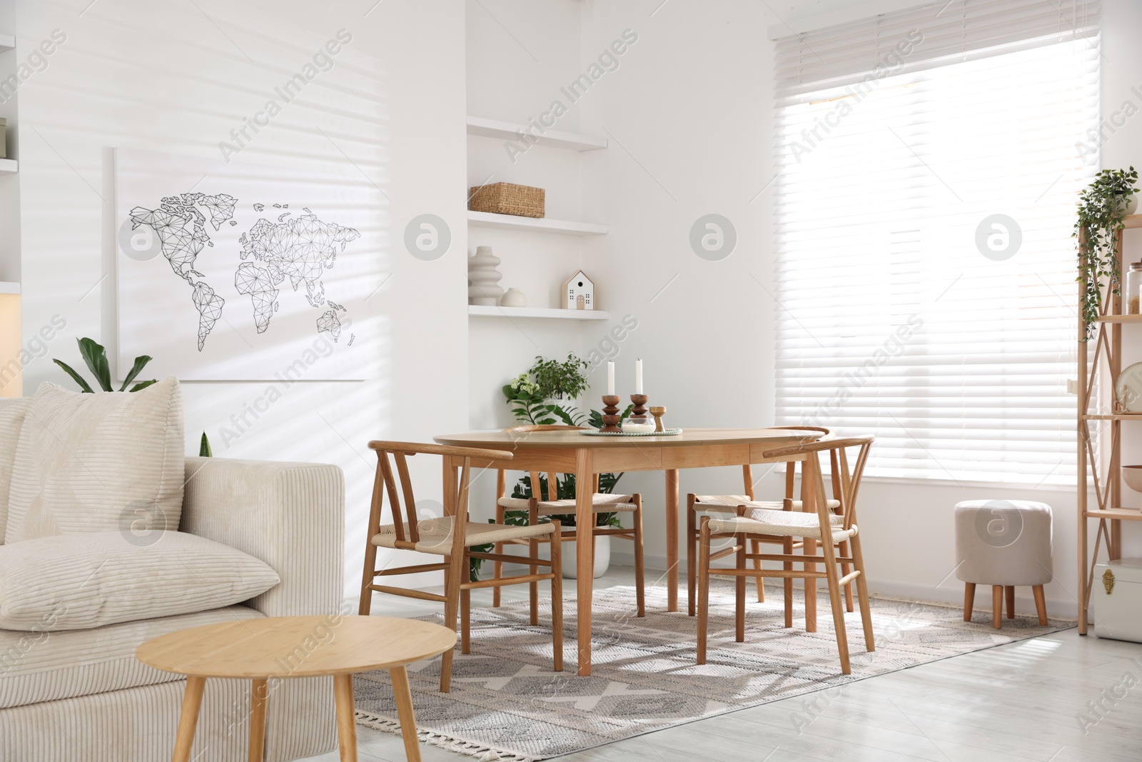 Photo of Stylish wooden table with chairs and decor indoors. Interior design