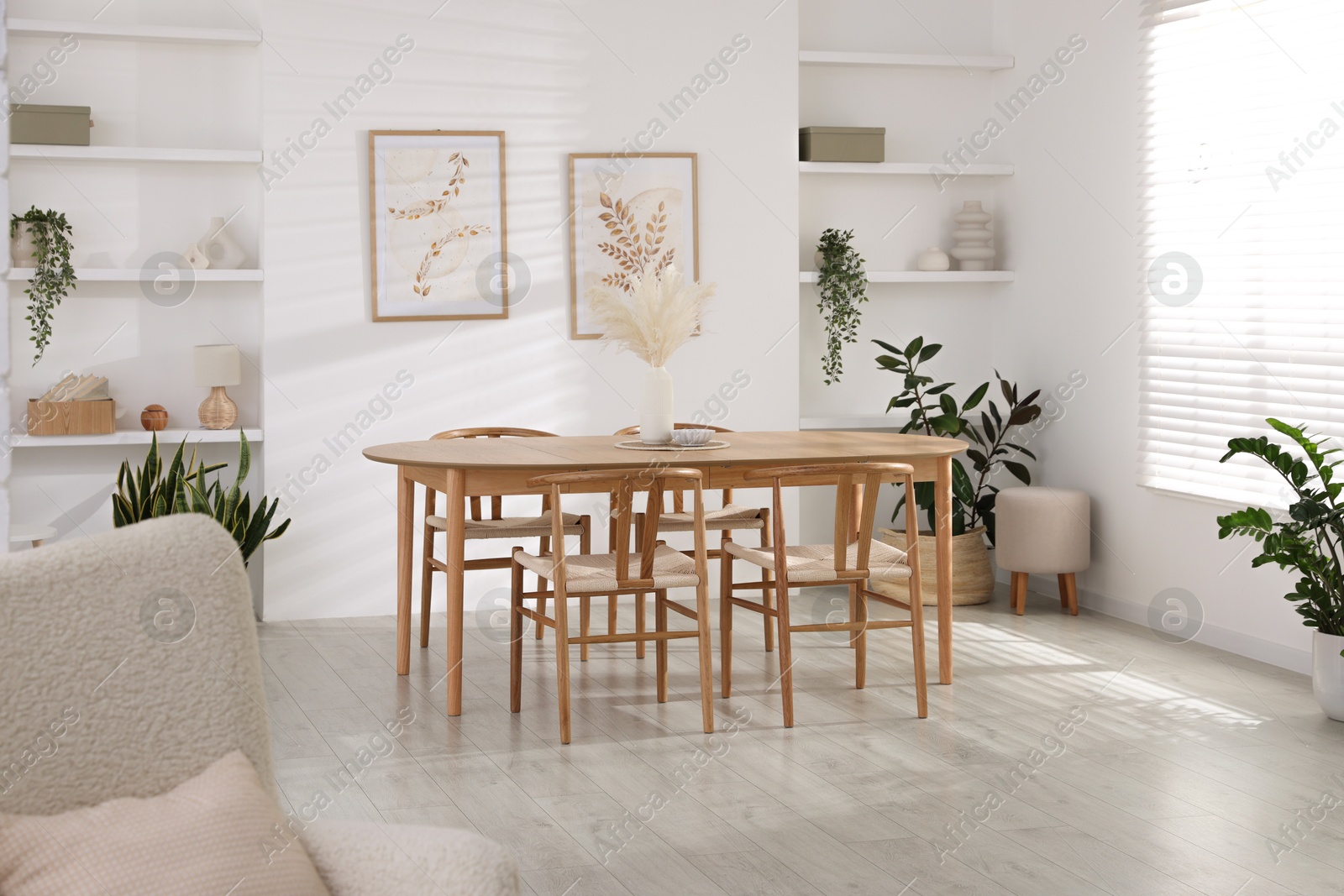 Photo of Stylish wooden table with chairs and decor indoors. Interior design