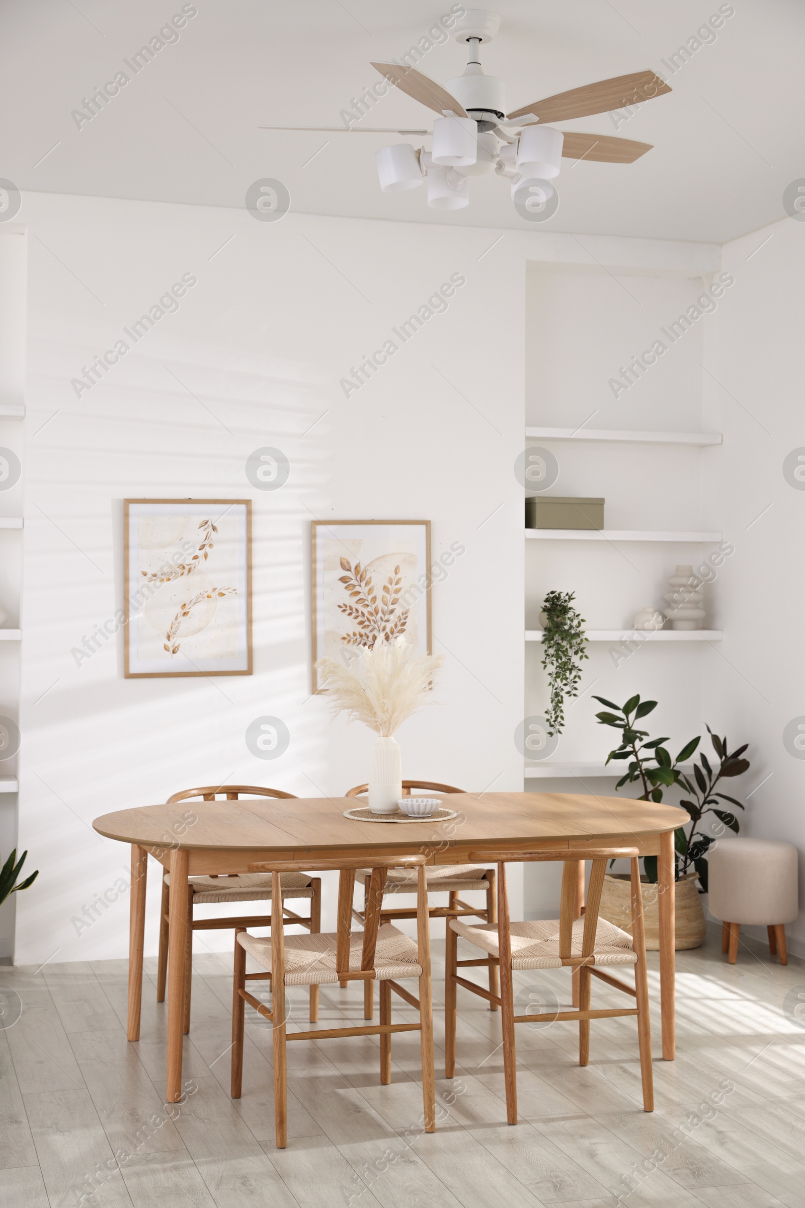 Photo of Stylish wooden table with chairs and decor indoors. Interior design