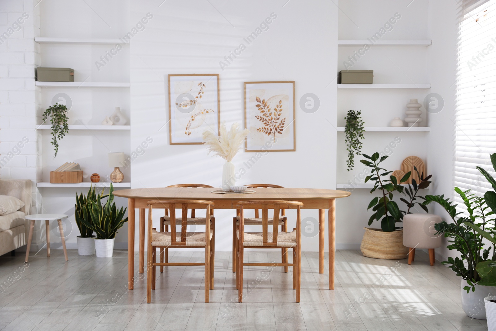 Photo of Stylish wooden table with chairs and decor indoors. Interior design