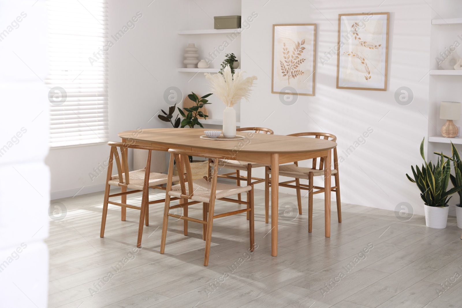 Photo of Stylish wooden table with chairs and decor indoors. Interior design