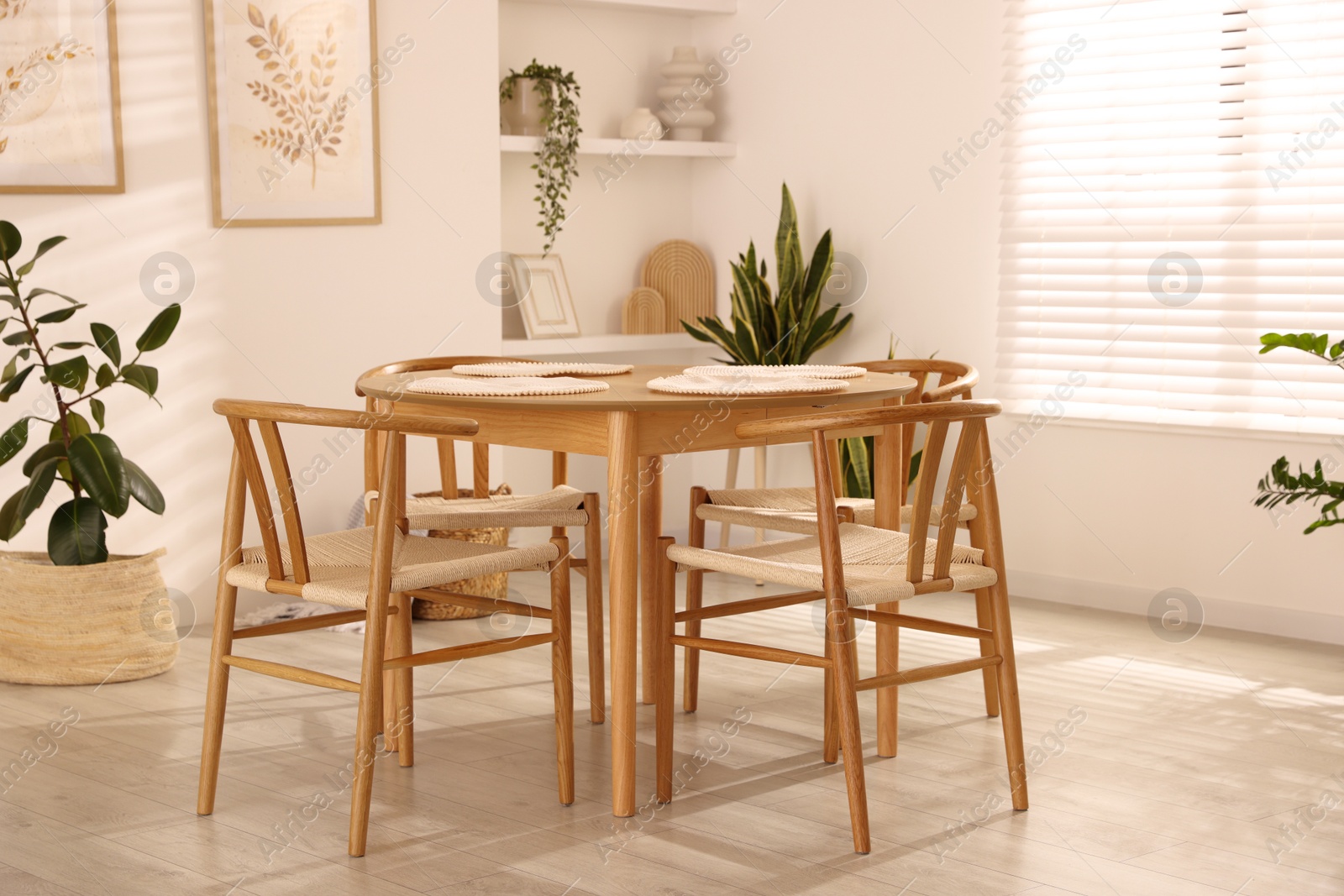 Photo of Stylish wooden table with chairs and decor indoors. Interior design