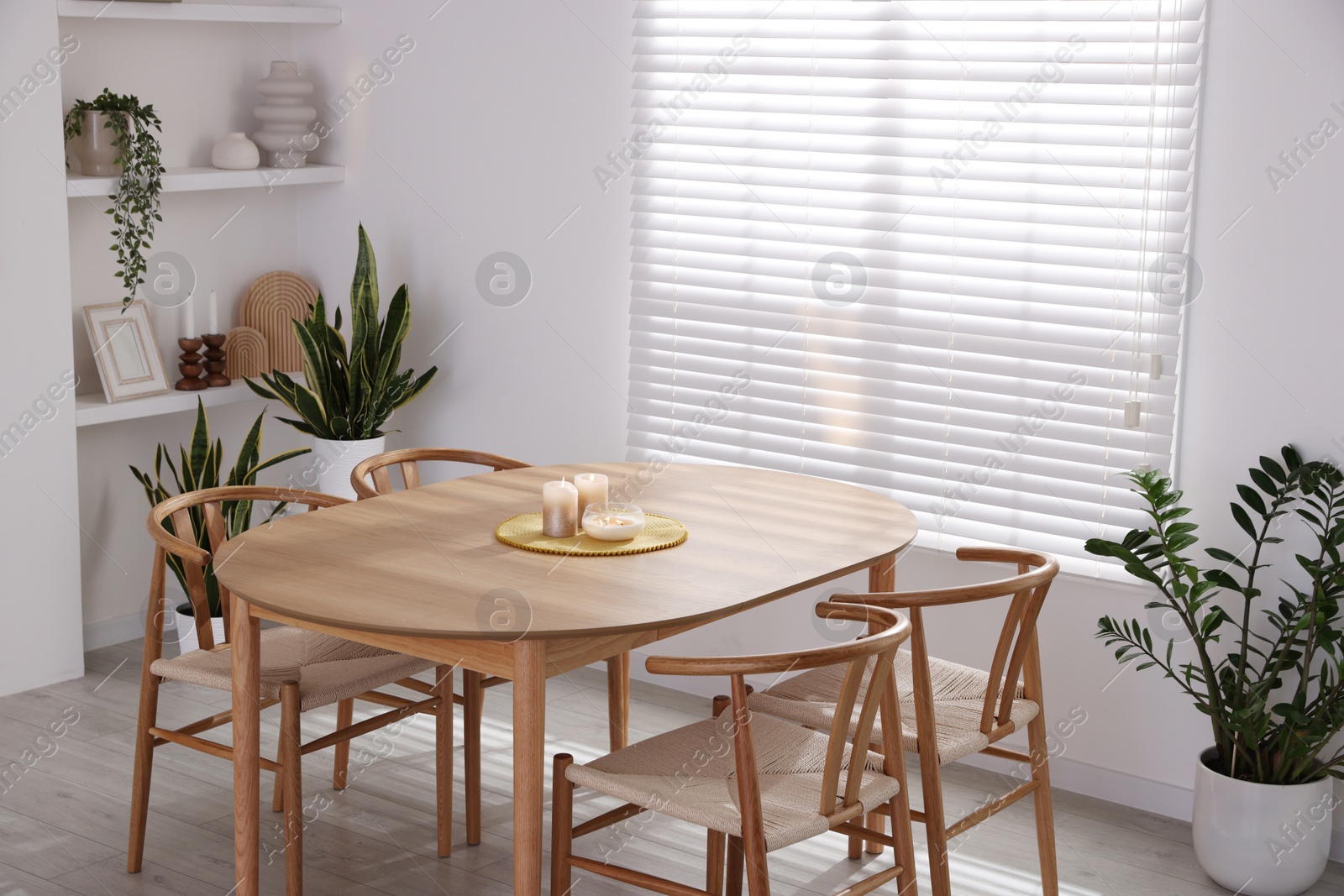 Photo of Stylish wooden table with chairs and decor indoors. Interior design