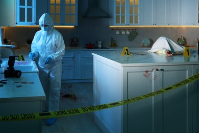 Photo of Forensic expert working at crime scene and dead body in dark room