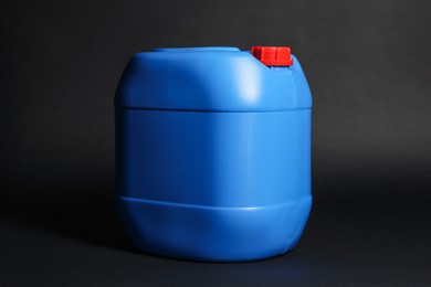 Photo of One plastic canister on black background, space for text