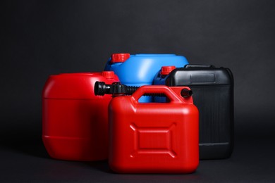 Photo of Many different plastic canisters on black background