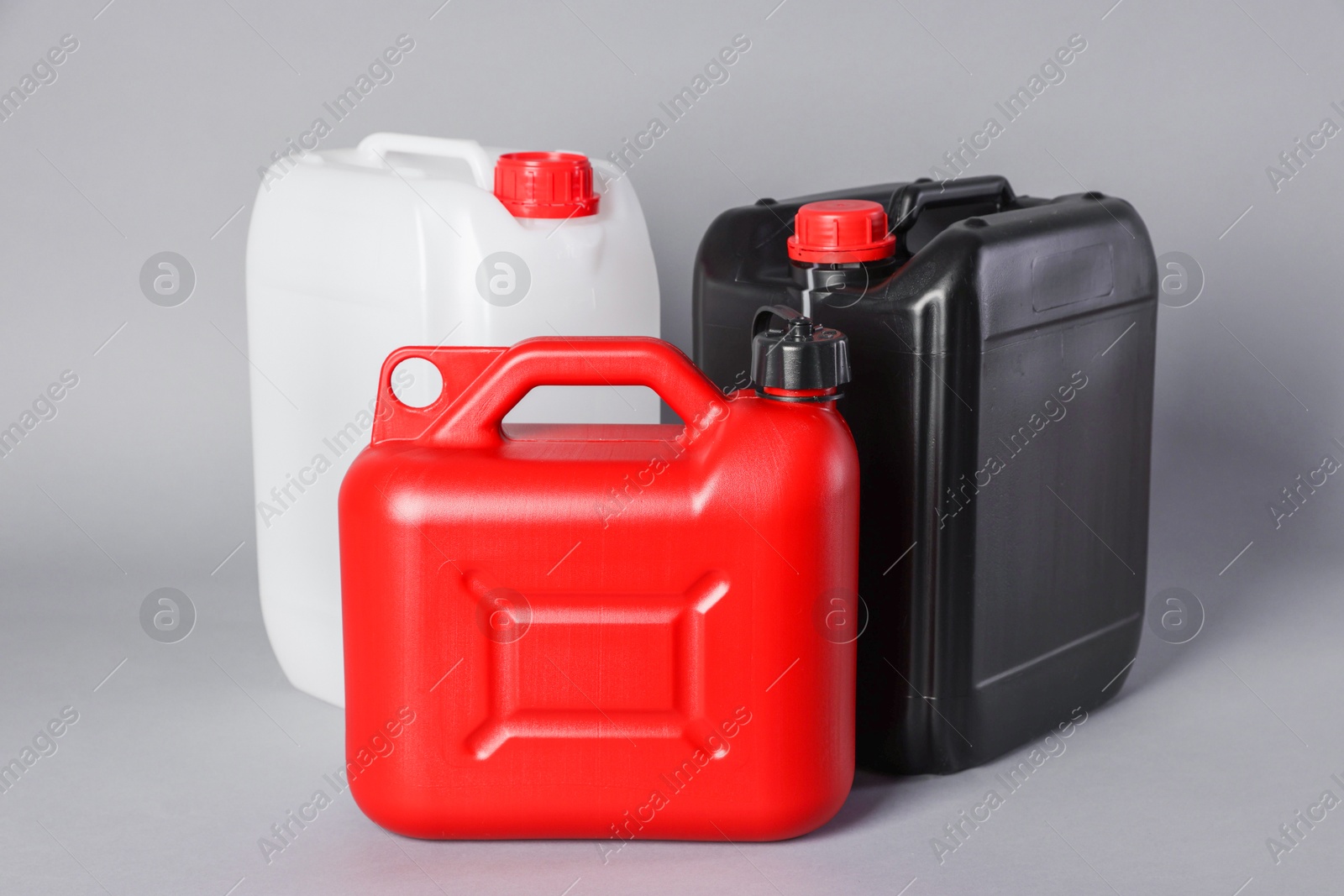 Photo of Many different plastic canisters on light grey background