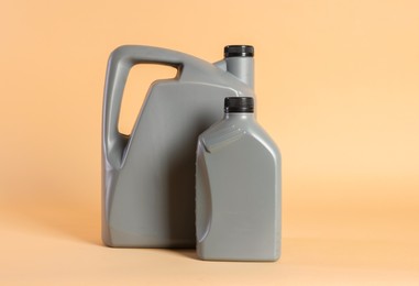 Photo of Two grey plastic canisters on beige background