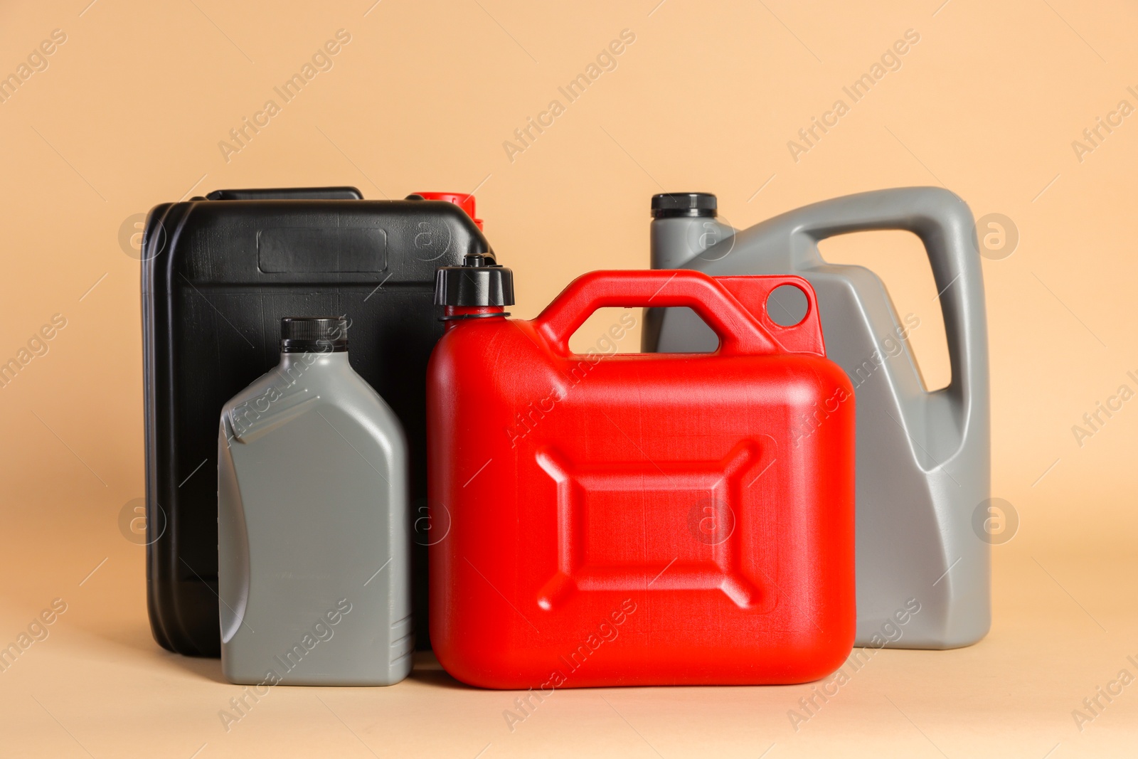 Photo of Many different plastic canisters on beige background