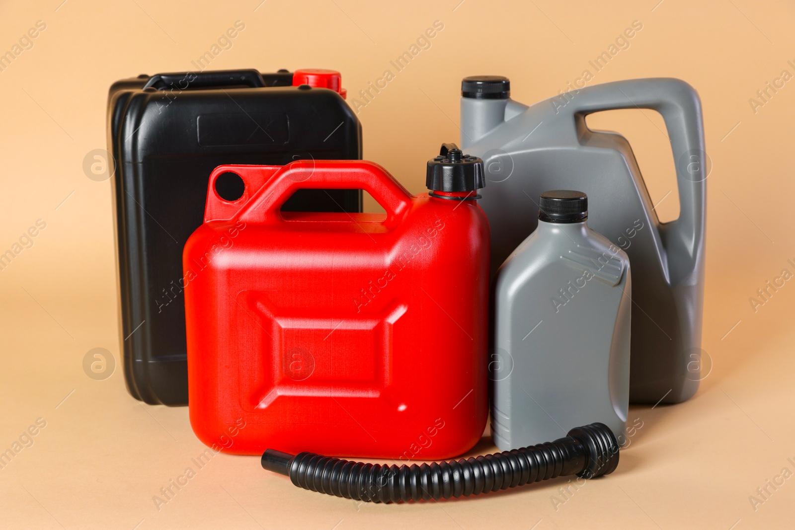 Photo of Many different plastic canisters on beige background