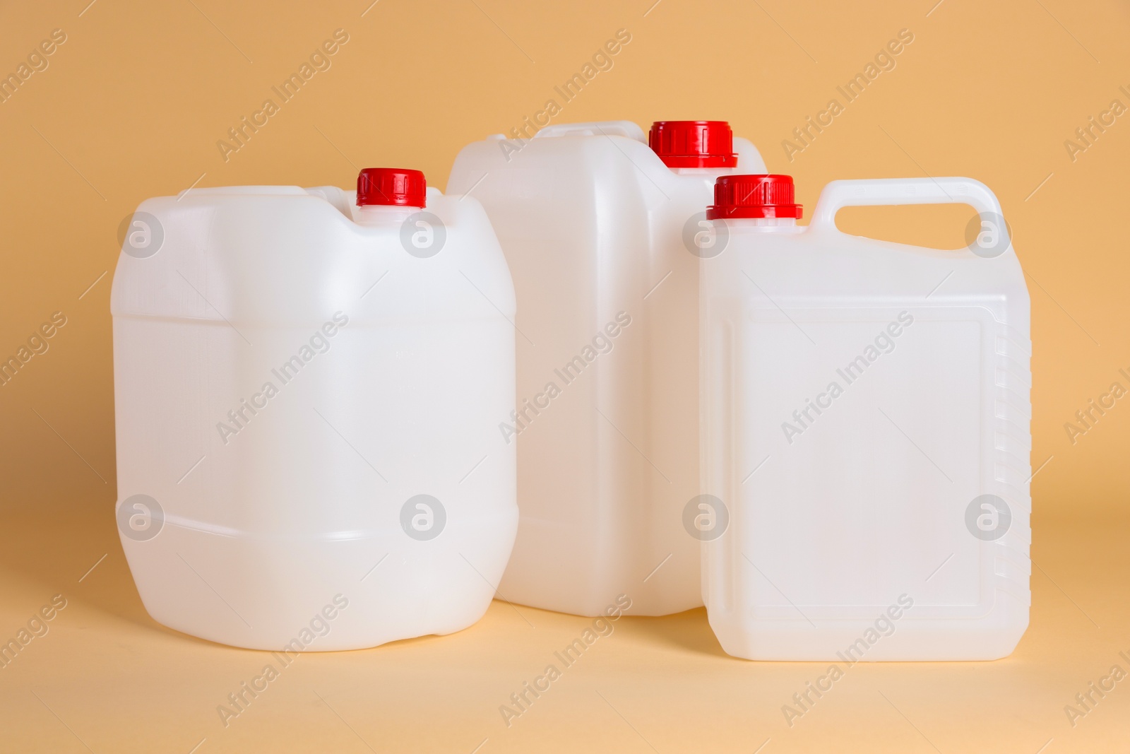 Photo of Many white plastic canisters on beige background