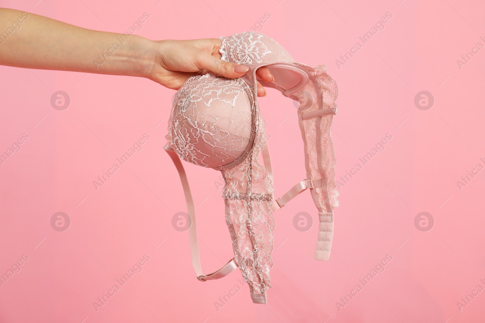 Photo of Woman with lace bra on pink background, closeup. Space for text