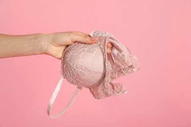 Photo of Woman with lace bra on pink background, closeup. Space for text