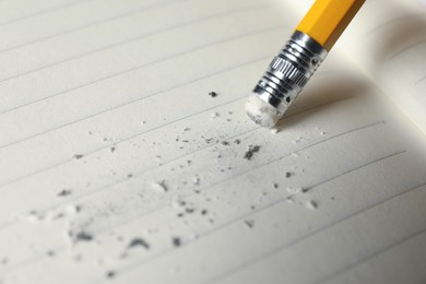 Photo of Using pencil with eraser on sheet of paper, closeup