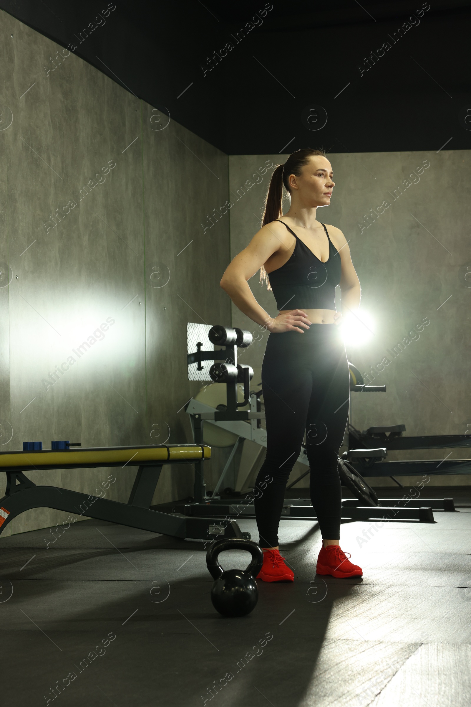 Photo of Athletic woman training with kettlebell in gym