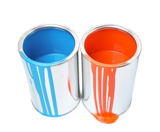 Photo of Cans of light blue and orange paints isolated on white