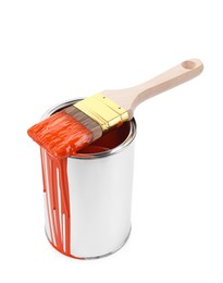 Photo of Can of orange paint and brush isolated on white