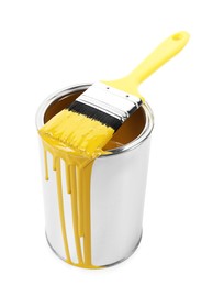 Photo of Can of yellow paint and brush isolated on white