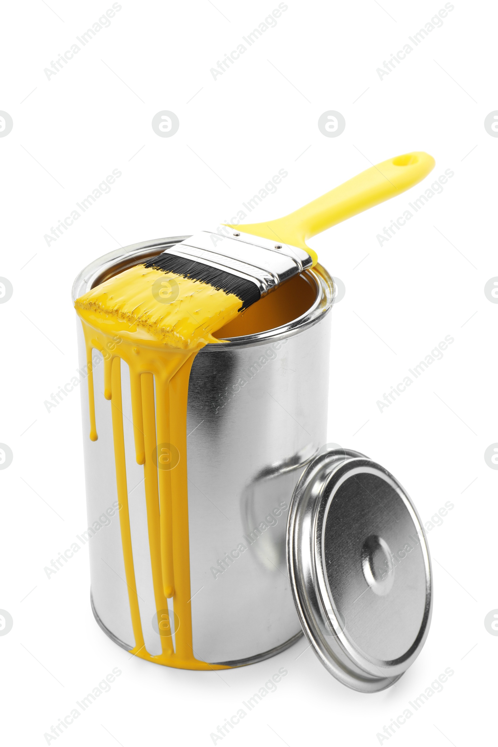 Photo of Can of yellow paint and brush isolated on white