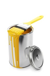 Photo of Can of yellow paint and brush isolated on white