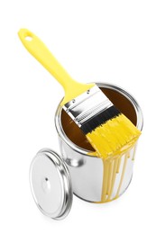 Photo of Can of yellow paint and brush isolated on white