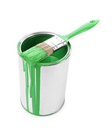 Photo of Can of light green paint and brush isolated on white